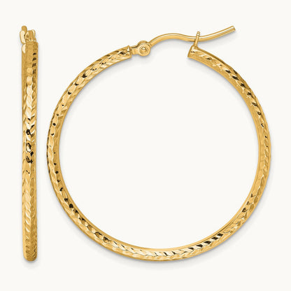 Diamond-cut Round Tube Hoop Earrings — 10K Yellow Gold