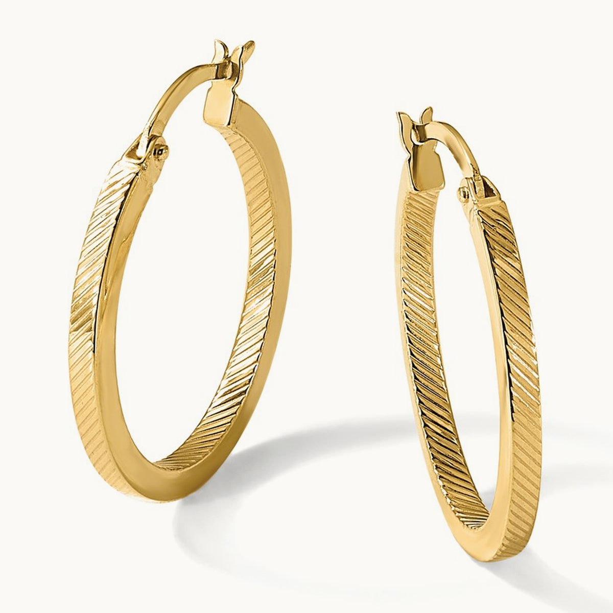 Polished and Textured Oval Hoop Earrings — Leslie's — 25mm