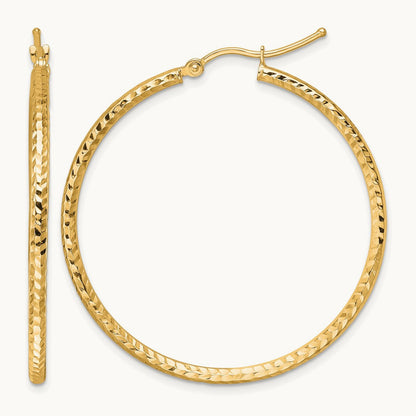 Diamond-cut Round Tube Hoop Earrings — 10K Yellow Gold