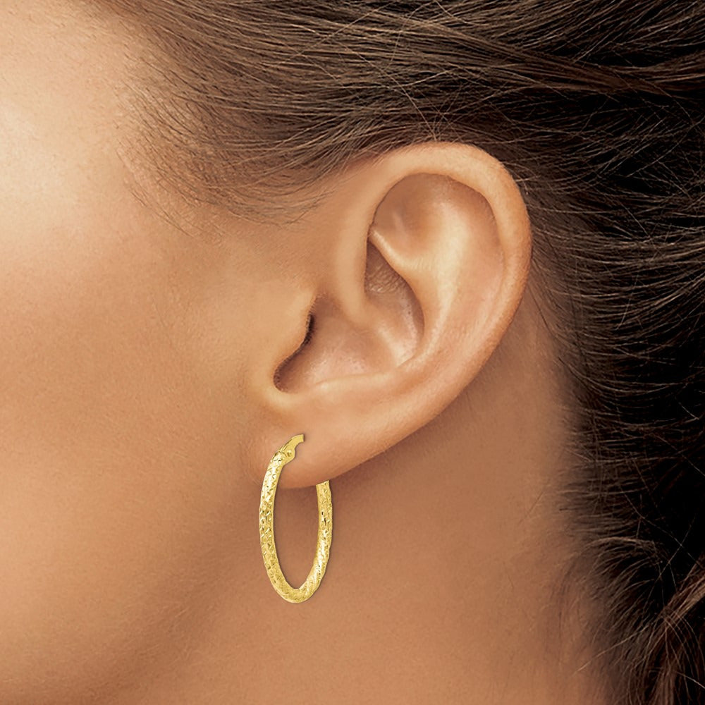 Polished Diamond-cut Oval Hoop Earrings — 10K Yellow Gold