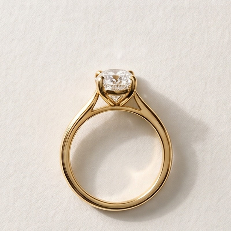 The finished yellow gold engagement ring with an oval diamond